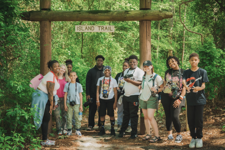 students posing with cameras on a trip