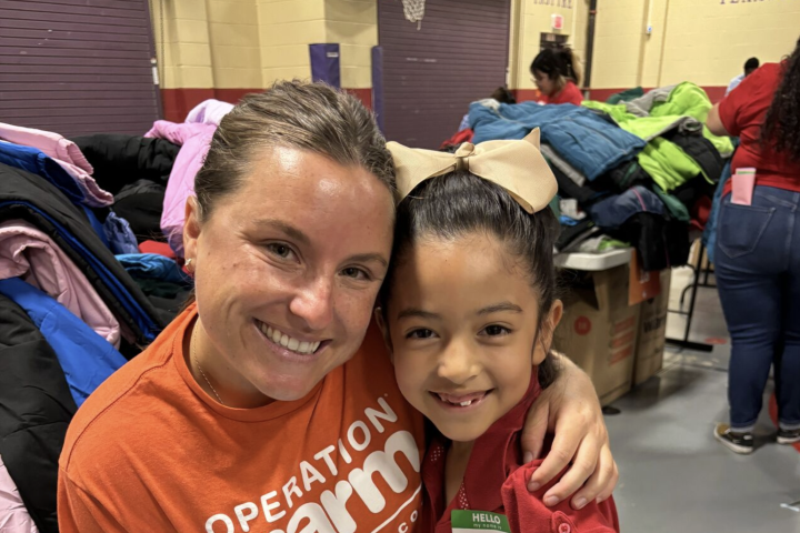 a volunteer distributing coats