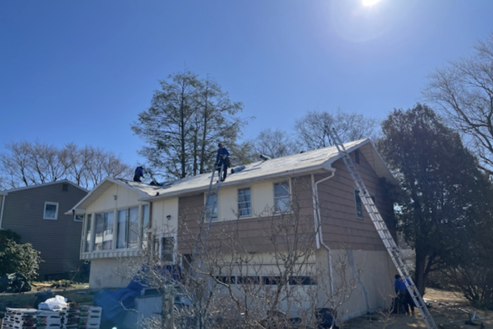volunteers working on a house