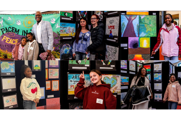 students posing with their art