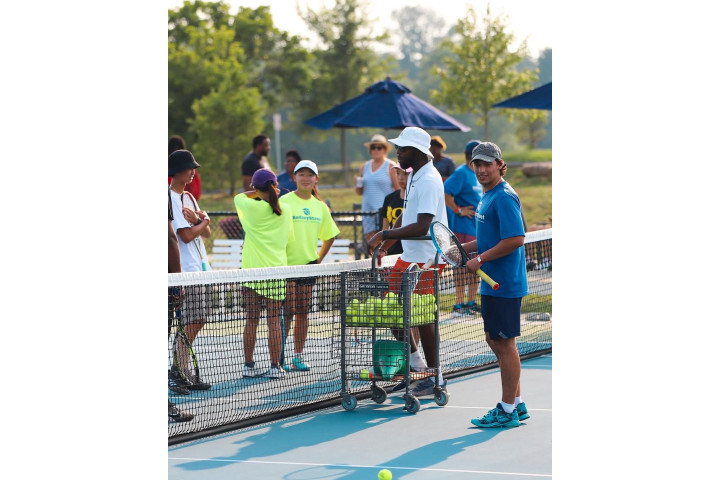 kids and instructors preparing for tennis camp