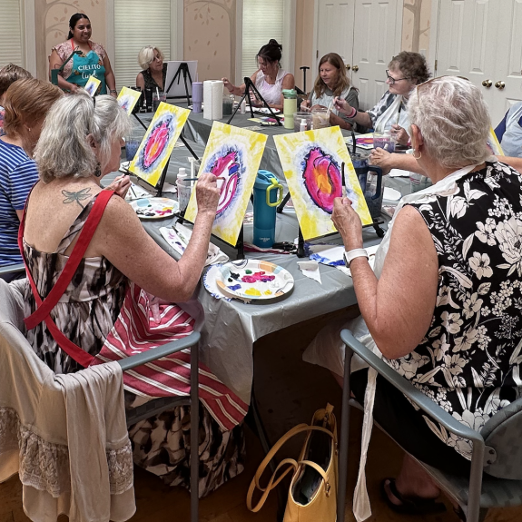 Participants painting in an arts therapy class