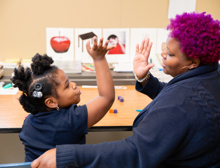 a teacher and student giving high five